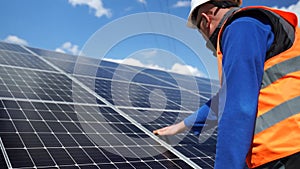 Solar power plant worker makes a visual inspection of solar panels. Renewable energy concept.