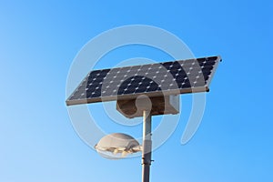 Solar powered city lamp isolated on blue sky photo