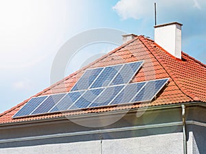 Solar roof panels with the sun flares on sky. Popular solar energy panels photo