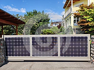 Solar sliding gate with solar panels at house driveway