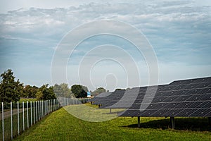 Solar system panels in the large photovoltaic power plant in the green field