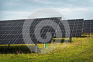 Solar system panels in the large photovoltaic power plant in the green field