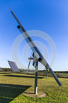 Solar system, solar power plant with trackable elements in sunshine, Side view with servomotor