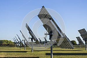 Solar system, solar power plant with trackable elements in sunshine, Side view with servomotor