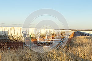A Solar thermal power plant panels in the middle of the field.