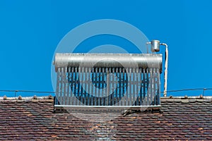 Solar water heater boiler on rooftop, visible bird excrements