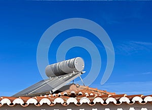 Solar water heater installed on tile roof of house for environmentally