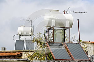 Solar water heating systems with large water tanks and boilers on roof of house