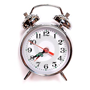 Solated vintage analog alarm clock on a white background. Seven forty am on alarm clock