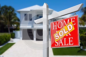 Sold Home For Sale Real Estate Sign in Front of Beautiful New House.