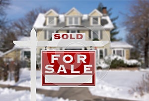 Sold Home For Sale Real Estate Sign in Front of New Snow Covered House