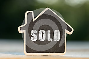 Sold written on the little house shape tag - real estate concept