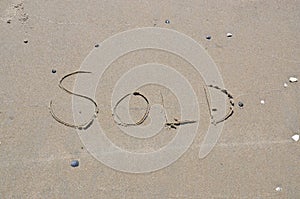 Sold written in the sand on the beach