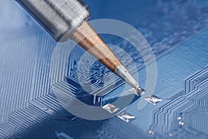 Soldering electronic components onto the PCB. Electronics repair and digital technology