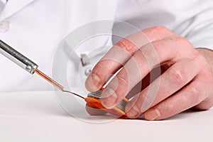 Soldering iron in his hand