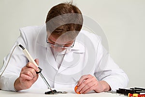 Soldering iron in his hand