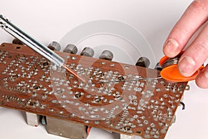 Soldering iron in his hand