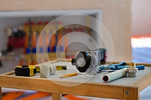 Soldering iron for polypropylene plumbing pipes. The hands of the plumber are holding the pipeline parts.