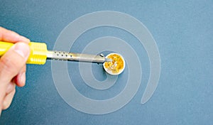 Soldering iron, tin, rosin on a yellow background. Macro. Repair of electrical equipment, radio engineering. Solder wires,