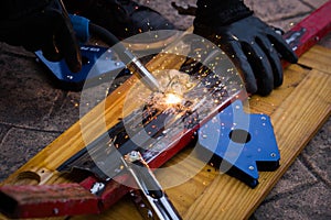 Soldering iron with a welding torch between sparks