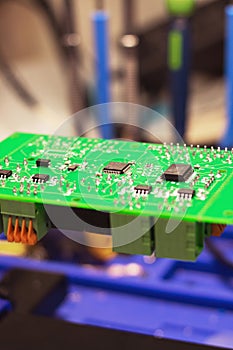 Soldering process on a green PCB closeup