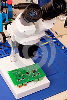 Soldering process on a green PCB closeup