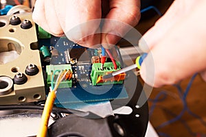 Soldering process on a green PCB closeup