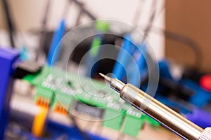Soldering process on a green PCB closeup