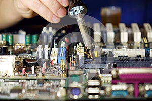 Soldering to a circuit Board of a computer close up.