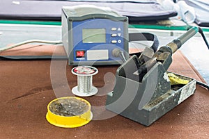 The soldering tools, tin, soldering iron, rosin on table