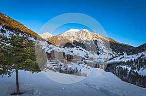 Soldeu village with mountain range illuminated by sunset in the background, Andorra