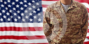 Soldier in an American military digital pattern uniform, standing on a USA flag background