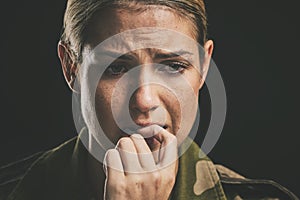 Soldier, anxiety and depression bite nails on hand to help with nerves in closeup with black background. Woman, mental