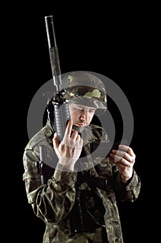 Soldier changing magazine of m16 photo