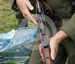 soldier while charging gun during a simulation of war