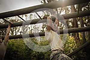 Soldier climbing monkey bars