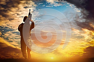 Soldier in combat shooting with his weapon, rifle. War, army concept