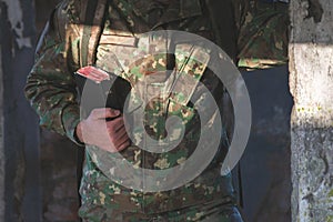 Soldier dressed in camouflage uniform holding a bible in his hand. Soldier reading and meditating on God's word