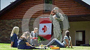 Soldier with family on green backyard