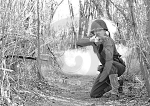 Soldier Firing M1 Rifle from Kneeling Position photo