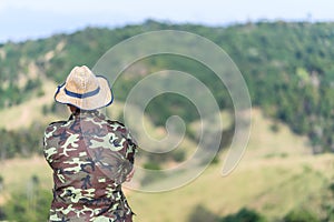 Soldier or Forest officials looking at mountain