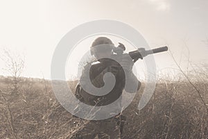 Soldier in full NATO uniform in fog