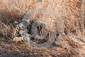 Soldier in full NATO uniform hiding in bushes