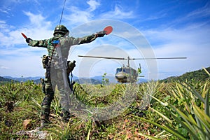 Soldier gives signal to helicopter