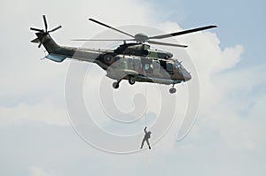 Soldier hanging from a helicopter