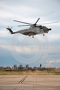 Soldier hanging from an italian helicopter