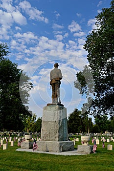 Soldier in heaven - statue in cemetery with memorial veterans independence day flags