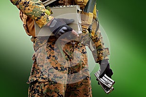 Soldier Holding the rifle 5.56mm loader on grren background