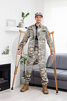 soldier in khaki military uniform on crutches