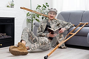 soldier in khaki military uniform on crutches